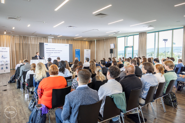 Audience in an event hall, picture taken from the back 