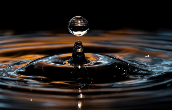 Water surface and a drop falling
